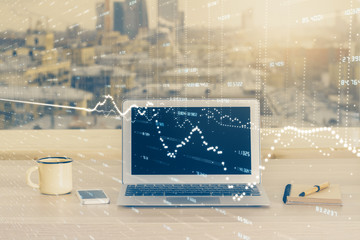 Financial graph colorful drawing and table with computer on background. Double exposure. Concept of...