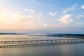 Fototapeta premium 夏の夕暮れの北浦とJR鹿島線、国道51号の新神宮橋などを俯瞰撮影