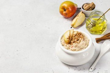 Cinnamon honey pear oatmeal porridge. Selective focus, space for text.