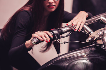 Fototapeta na wymiar close up. woman model riding on a cool motorbike.