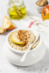Cinnamon honey pear oatmeal porridge. Selective focus, space for text.