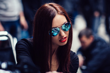 close up. stylish woman biker riding a motorcycle