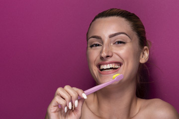 Young girl with toothbrush laughing