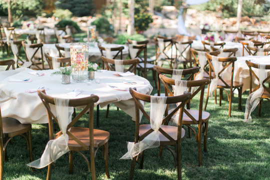 Chairs and table at outdoor summer wedding, wedding reception decor, ceremony