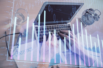 Multi exposure of forex graph with man working on computer on background. Concept of market analysis.