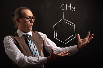 Professor presenting handdrawn chemical formula of toluene