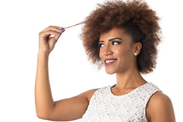 afro hair black brazilian girl smiling cheerfully and holding hair. Concept of hair care. Standing...