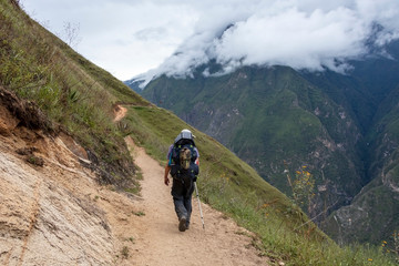 Young hiker man trekking with backpack in Peruvian Andes mountains, Peru, South America