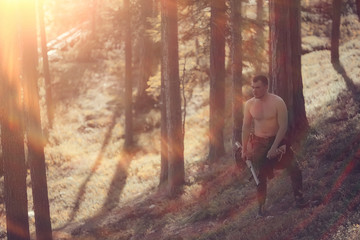 Fototapeta premium hunting man / hunter with a gun hunting in the autumn forest, yellow trees landscape in the taiga