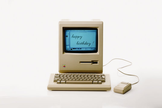 Aachen, Germany - March 14, 2014: Studioshot of an original Macintosh 128k called Apple Macintosh on white background. This was the first produced Mac, released on january 1984