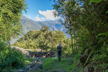 Young tourist with backpack hiking at high altitude Peruvian mountains, the Choquequirao trek to Machu Picchu, Peru