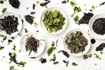 Various dry seaweed, sea vegetables, shot from above on white. Superfoods background