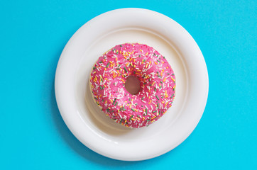 Pink donut in plate