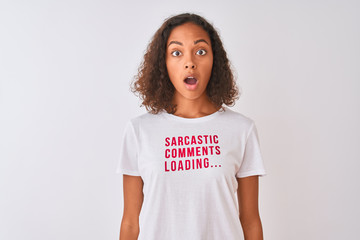 Brazilian woman wearing fanny t-shirt with irony comments over isolated white background scared in shock with a surprise face, afraid and excited with fear expression - obrazy, fototapety, plakaty