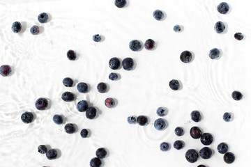 Organic blueberries in water on the white background. Top view