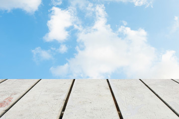 The blur cool blue sky white cloud with old Wooden table