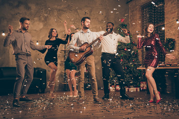 Fulll length photo of funny fellows enjoy music dance celebrate christmas night x-mas party in house with confetti falling indoors