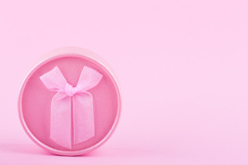 Pink round gift box on paper background