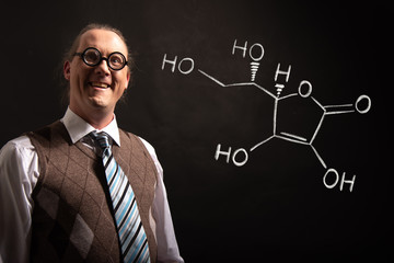 Professor presenting handdrawn chemical formula of Vitamin C