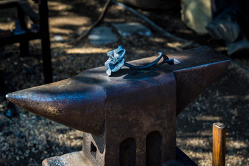 Workplace of a blacksmith anvil. Tools for metal processing. Close-up.