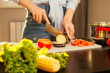 happy redhaired ginger woman cooking in evening sun lights sunset background