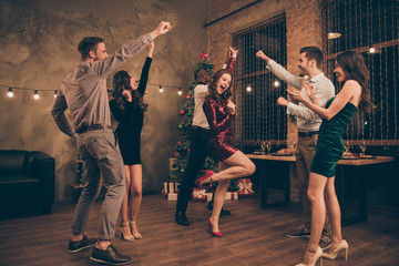 Full length photo of lovely guys and ladies having fun dancing on christmas x-mas party in house indoors