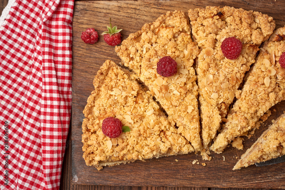 Poster sliced triangular pieces of crumble pie with apples