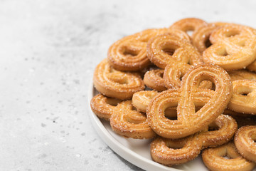 Cookies with sugar in a white plate on a light table