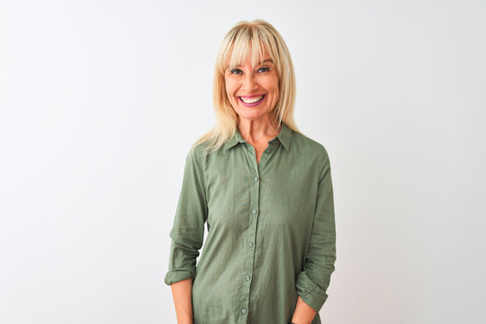 Middle age woman wearing green casual shirt standing over isolated white background with a happy and cool smile on face. Lucky person.