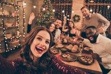 Close up photo of cheerful fellows in formal wear sit around table enjoy christmas party x-mas...