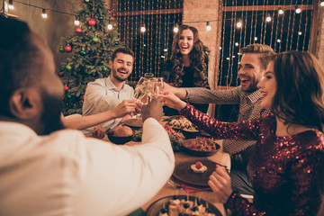 Nice attractive lovely glamorous smart stylish cheerful cheery positive excited glad guys spending weekend clinking greetings congrats congratulating over served desk in decorated house © deagreez