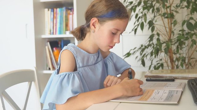 Little girl doing homework at home.