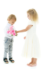 A little boy gives a girl a bouquet of flowers. The concept of l