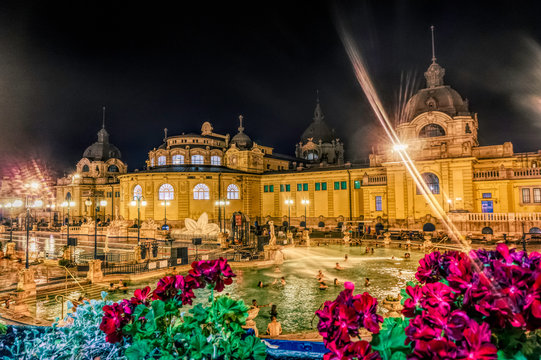 Budapest / Hungary - August 30 2019: Famous Secheni Thermal Pools in Budapest, Hungary. Having fun and bathing people. Wellness complex of public therapeutic pools and saunas for water treatments