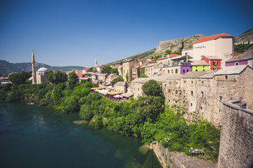 Mostar, Bosnia and Herzegovina, 20.6.2019. Skyline of Mostar with the Mostarthe old  Bridge, houses...