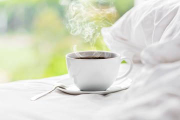 Hot coffee placed on the bed in the bedroom