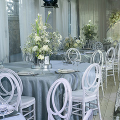 wedding dinning tables set up for dinning, decoration of white flowers, grey colour table cloth, elegant wedding 