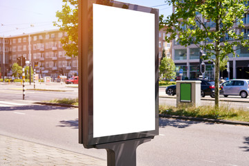 Mockup of a blank empty white advertising urban billboard, placeholder template city street, space for design layout, sunset light.