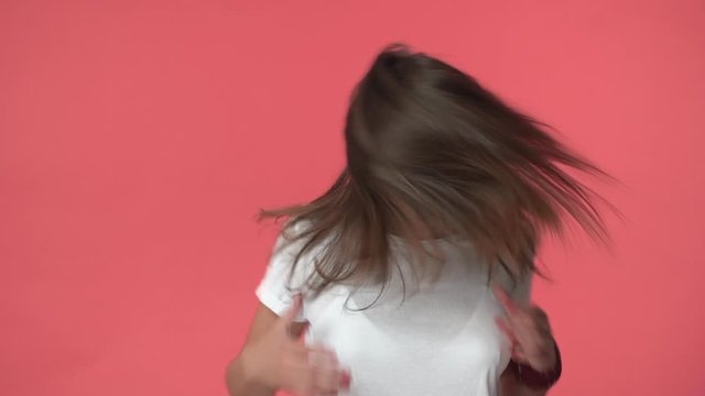 Carefree wild and free joyful, enthusiastic brunette woman with braces, whip hair shaking head, smiling happy camera, standing red background, finally got hair care treatment