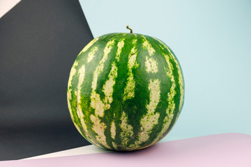 Watermelon on natural color background. Whole watermelon on pastel background. Healthy food for vegan. Copy space for text