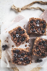 Raw vegan coconut chocolate dessert with blueberries, top view . Healthy vegan food concept.