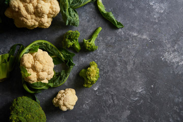 Organic cauliflower and broccoli on a plate on a dark