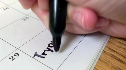 Tryouts written with a black marker on a calendar date page
