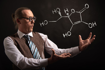 Professor presenting handdrawn chemical formula of Vitamin C