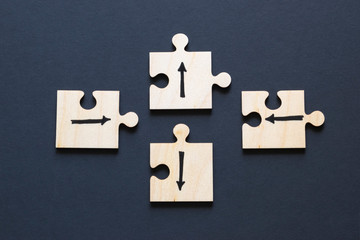 Choice concept, arrows drawn on wooden puzzles.