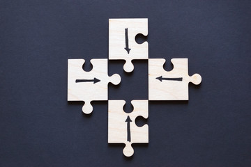 Choice concept, arrows drawn on wooden puzzles.