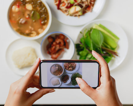 taking photo of thai food with smart phone