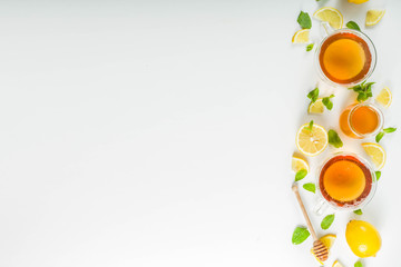 Autumn tea with mint and lemon with ingredient-s - fresh mint leaves, sliced lemon and honey, white background copy space 