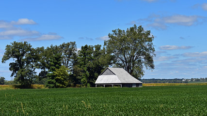 Rural landscape photo of a barn in a field