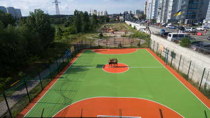 Obraz premium Soccer field among tall houses.